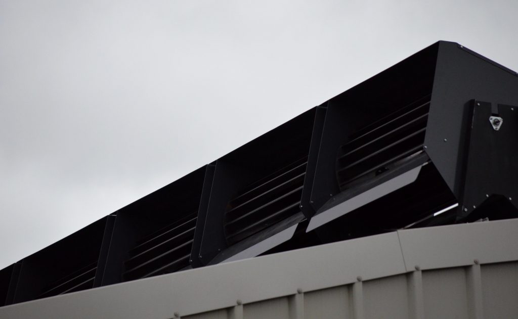 Modern full black solar panels on the roof of a house.